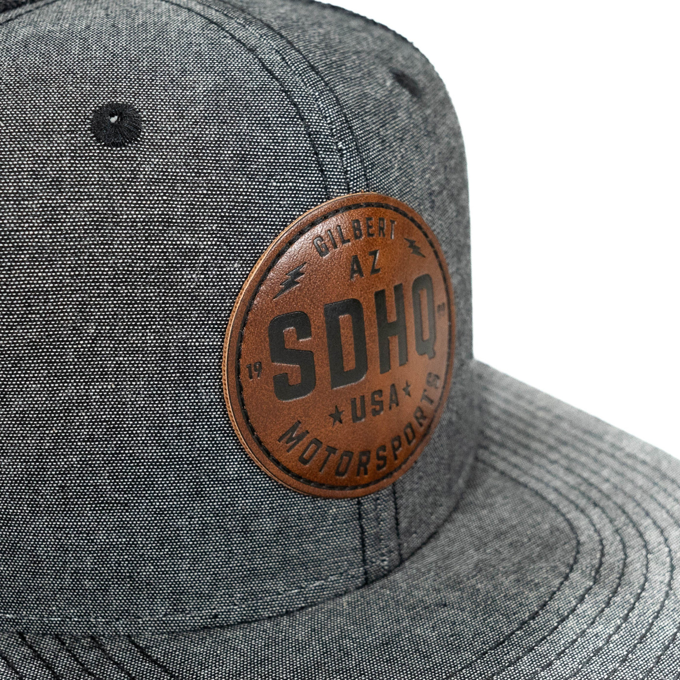 SDHQ Motorsports Flat Bill Trucker Hat | Charcoal Grey with Embossed Leather Patch