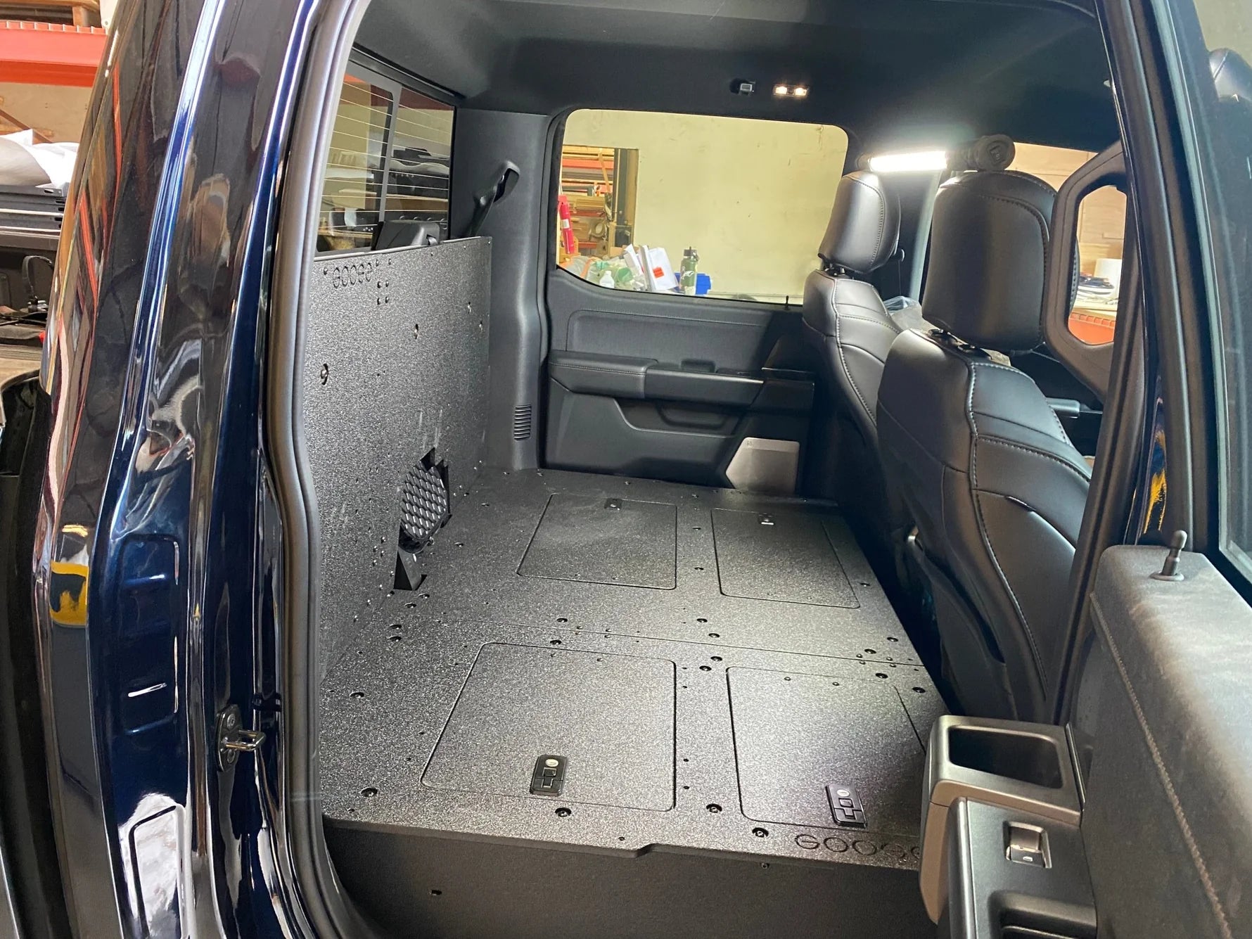 Ford - F150 2021-Present - 14th Gen. SuperCrew - Second Row Seat Delete Plate System with Factory B&O Subwoofer Center Wall with Exterior Port Front View