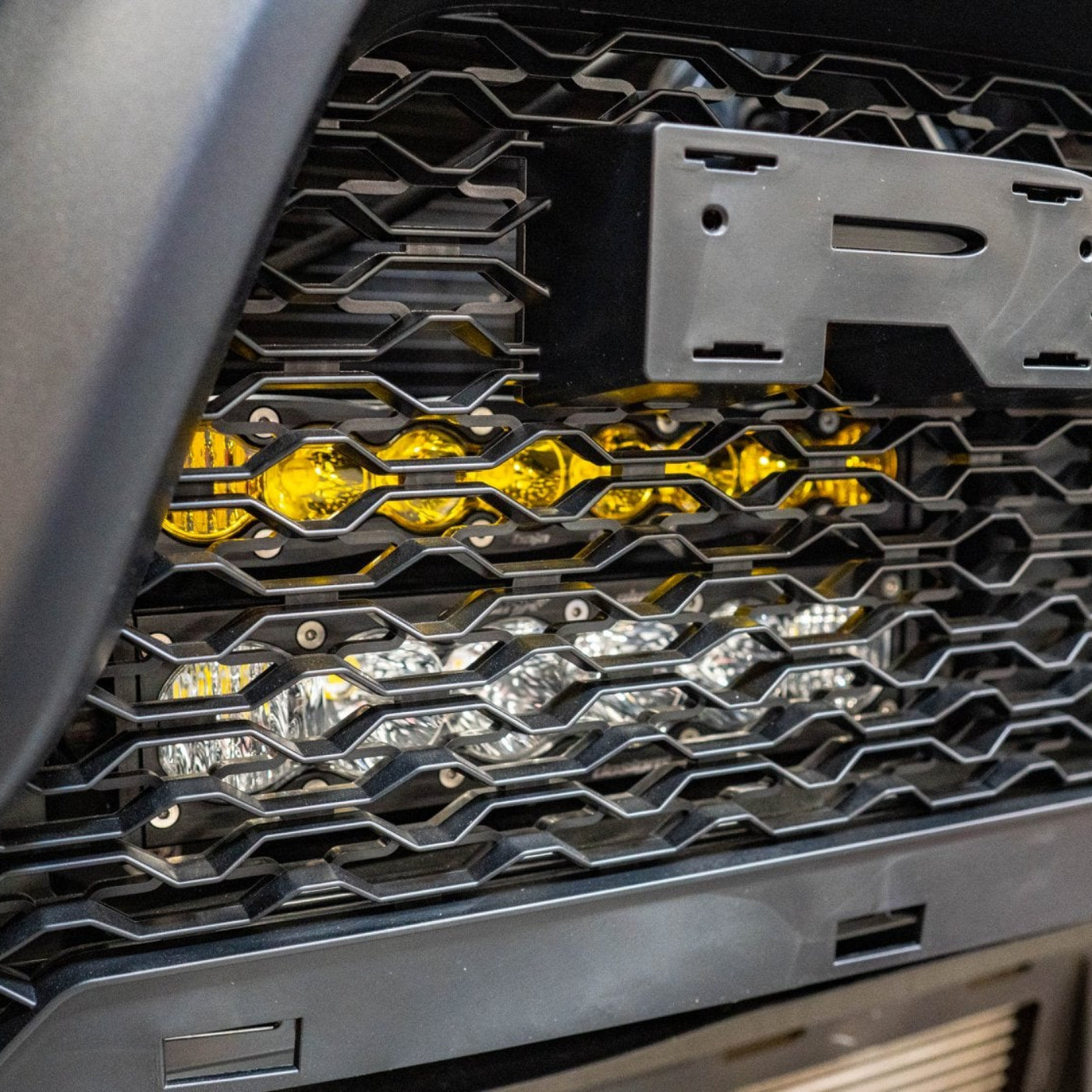 2025 Ram 1500 RHO SDHQ Built Behind the Grille LED Light Bar Mount installed - close-up 